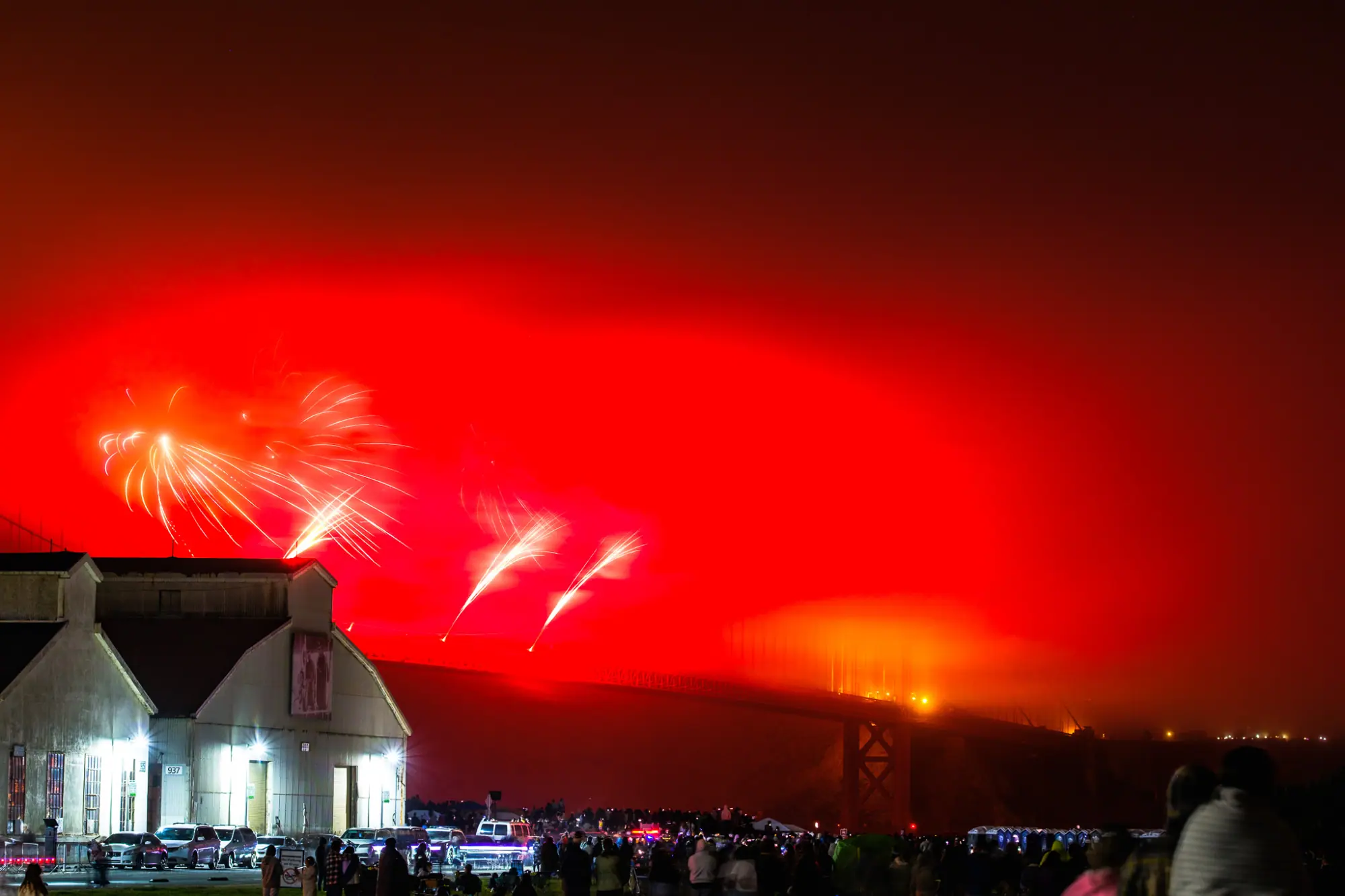 The fog glowing red over the bridge and the hangars